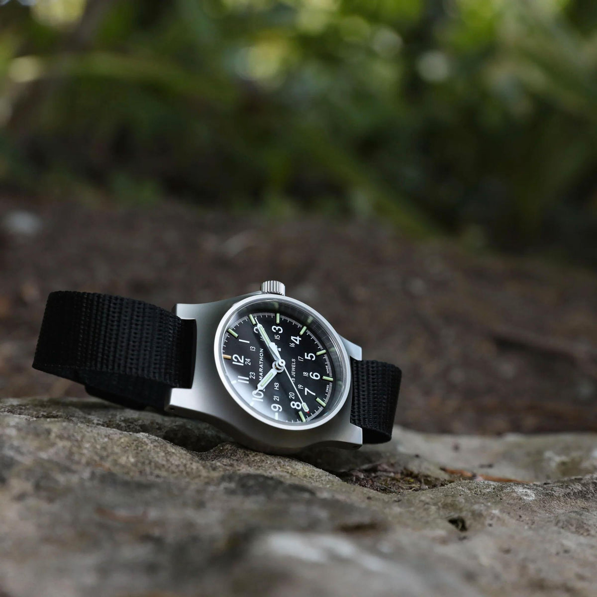 Marathon General Purpose Field WW194003SS-0001 mens field watch resting on rock surface outdoors