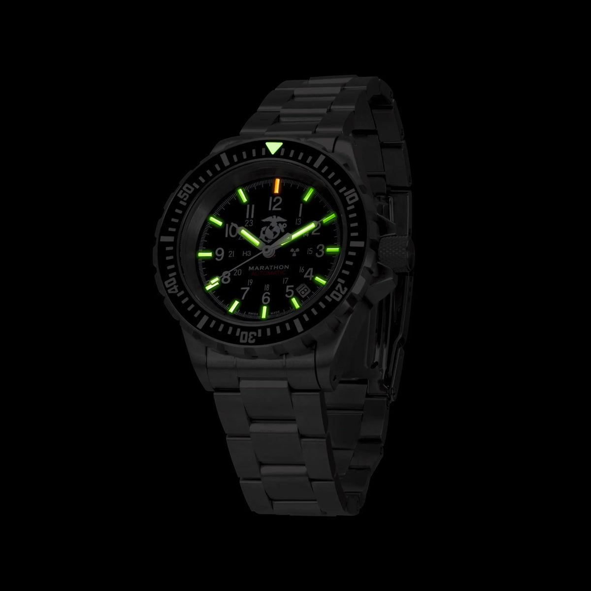 Marathon GSAR Official USMC WW194006SS-0208 automatic watch in dark lighting with glowing hands on black dial