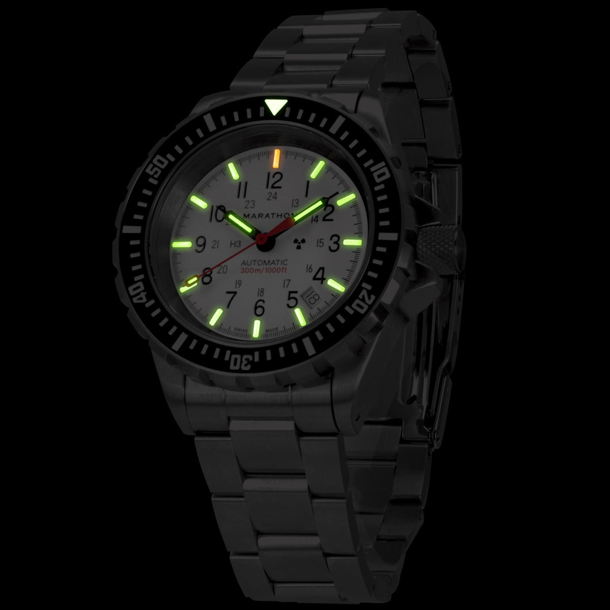 Marathon GSAR Arctic Edition WW194006SS-0513 automatic watch with glowing tritium gas tubes on a white dial in darkness