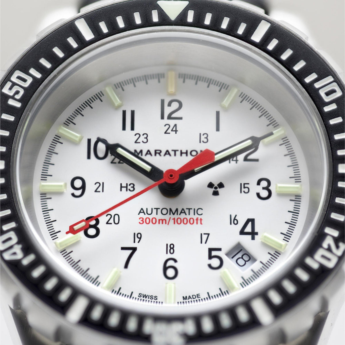 Close-up of Marathon GSAR Arctic Edition WW194006SS-0513 automatic watch front view showing white dial and black bezel