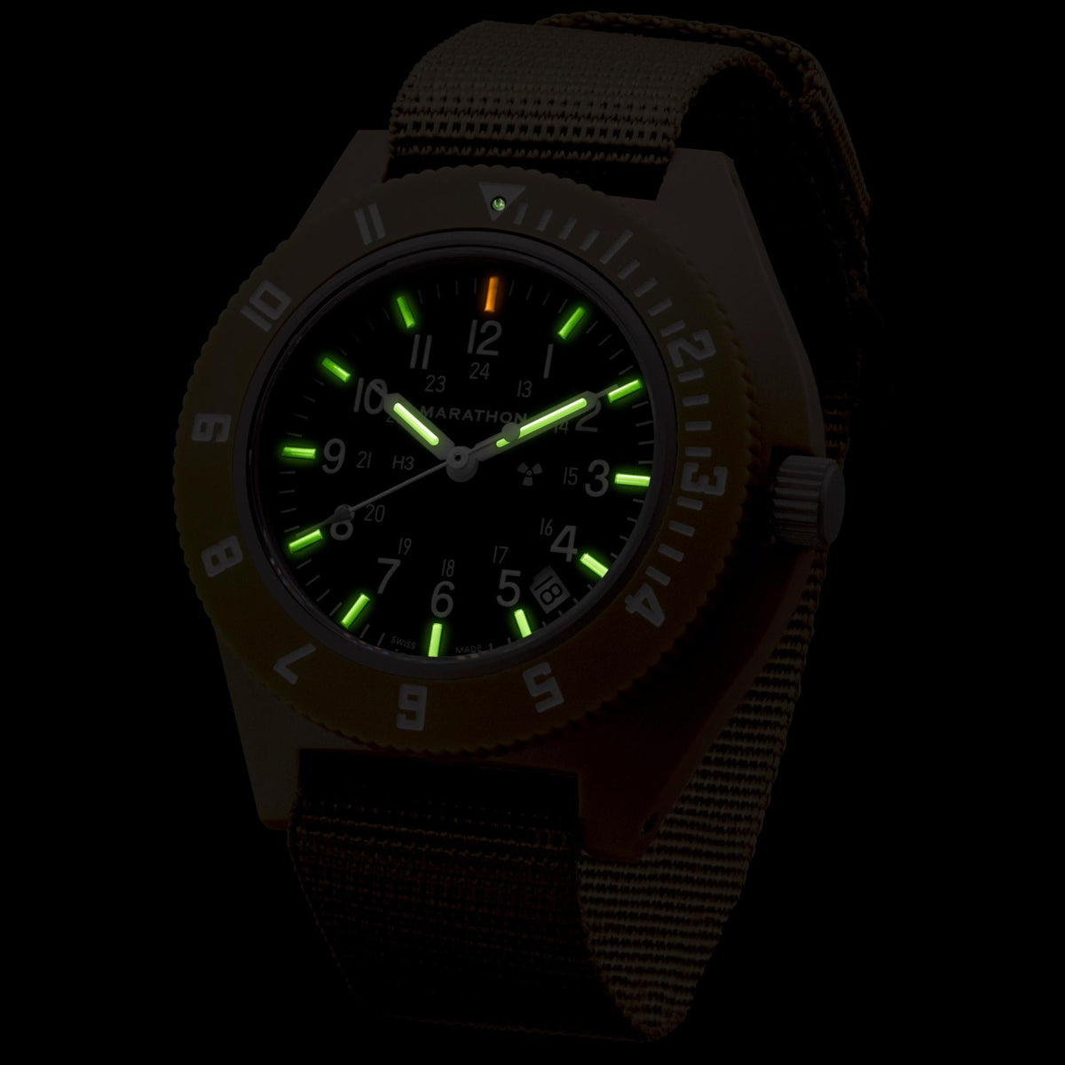 Marathon Navigator WW194013DT-0102 quartz watch displaying illuminated green indices in dark conditions