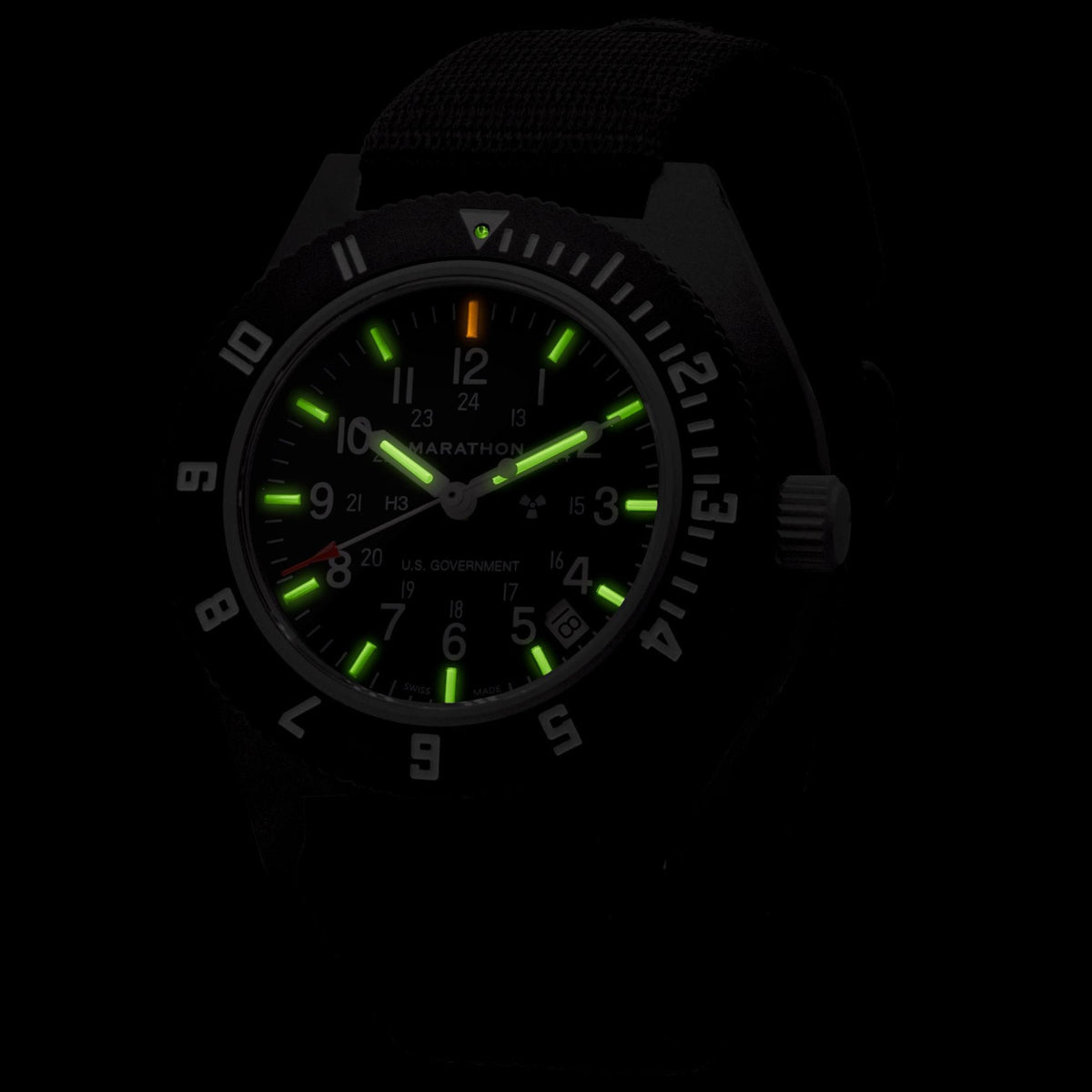 Marathon Navigator WW194013BK-0001 watch displaying glowing tritium markers in dark conditions
