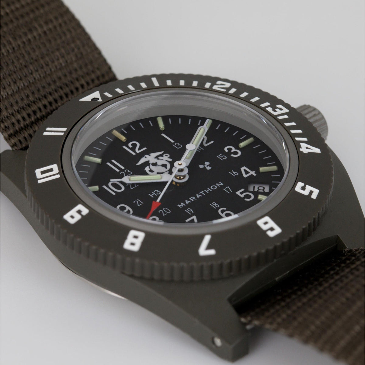 Marathon Navigator WW194013SG-0202 quartz watch macro shot highlighting black dial details with USMC insignia