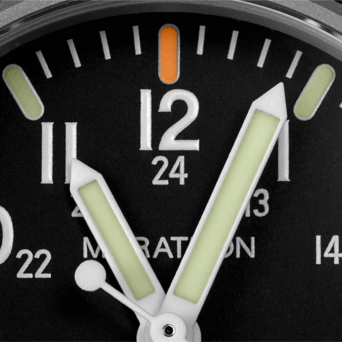 Marathon Navigator WW194013BK-2102 mens quartz watch macro shot highlighting luminescent hands and 12 o'clock orange marker