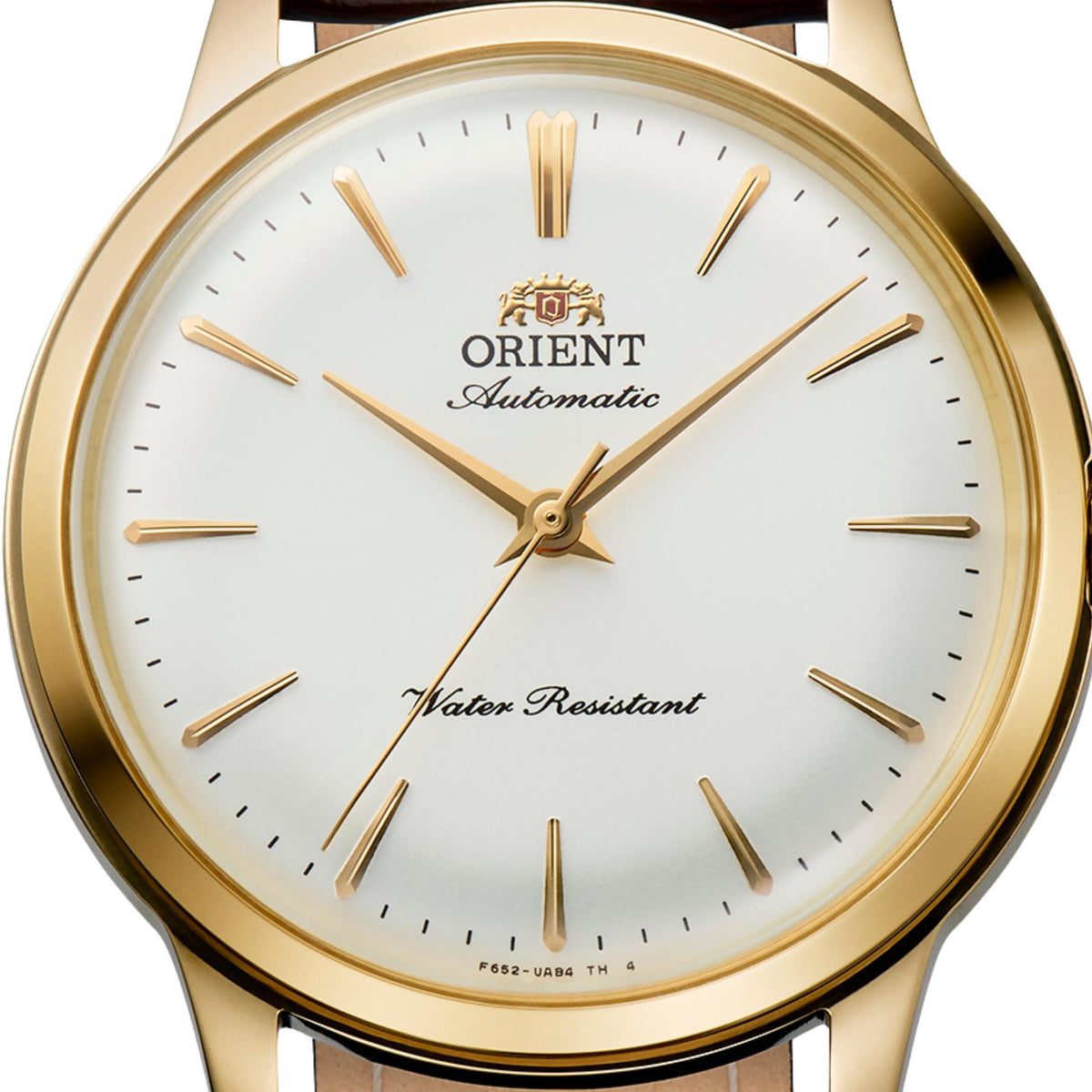 Close-up of the white dial, slim applied hour markers, and gold-tone hands on the Orient Bambino RA-BB0101S30B