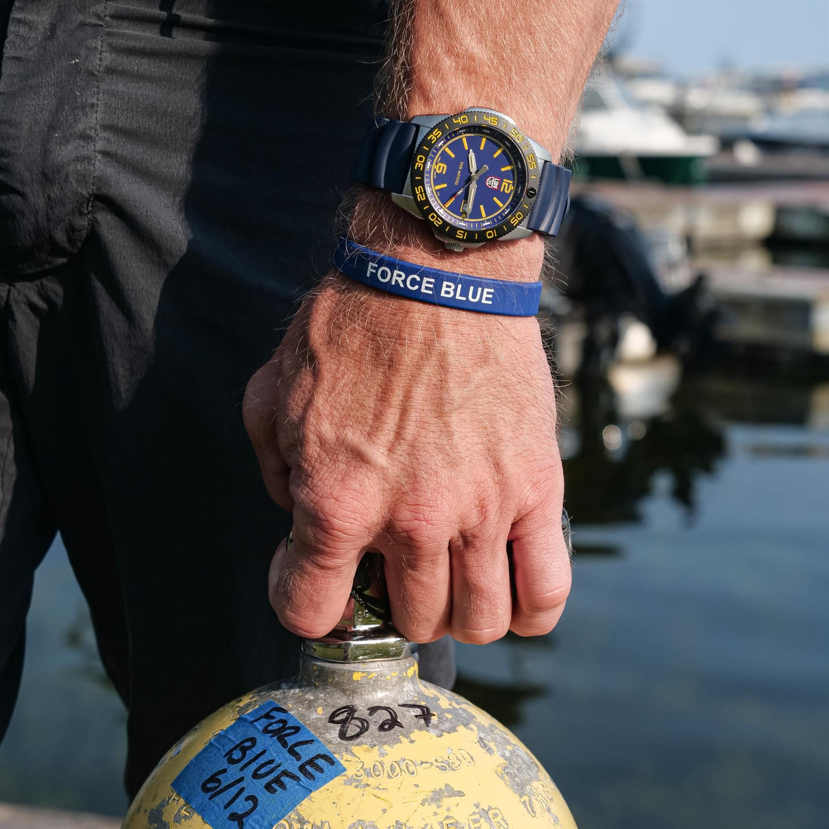 Luminox Pacific Diver FORCE BLUE 3120 Series XS.3125.FB watch worn on the wrist beside a yellow scuba tank