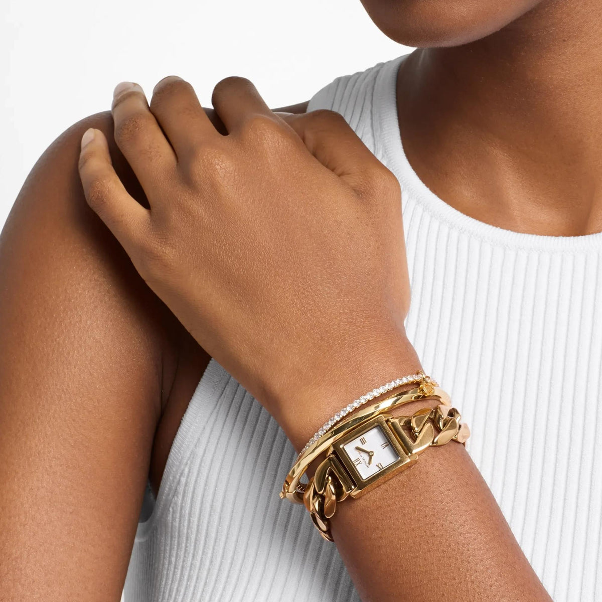 Michael Kors Georgie 19mm MK7655SET model shot view showing the silver dial curb chain watch paired with complementary gold-tone bangles worn on the wrist