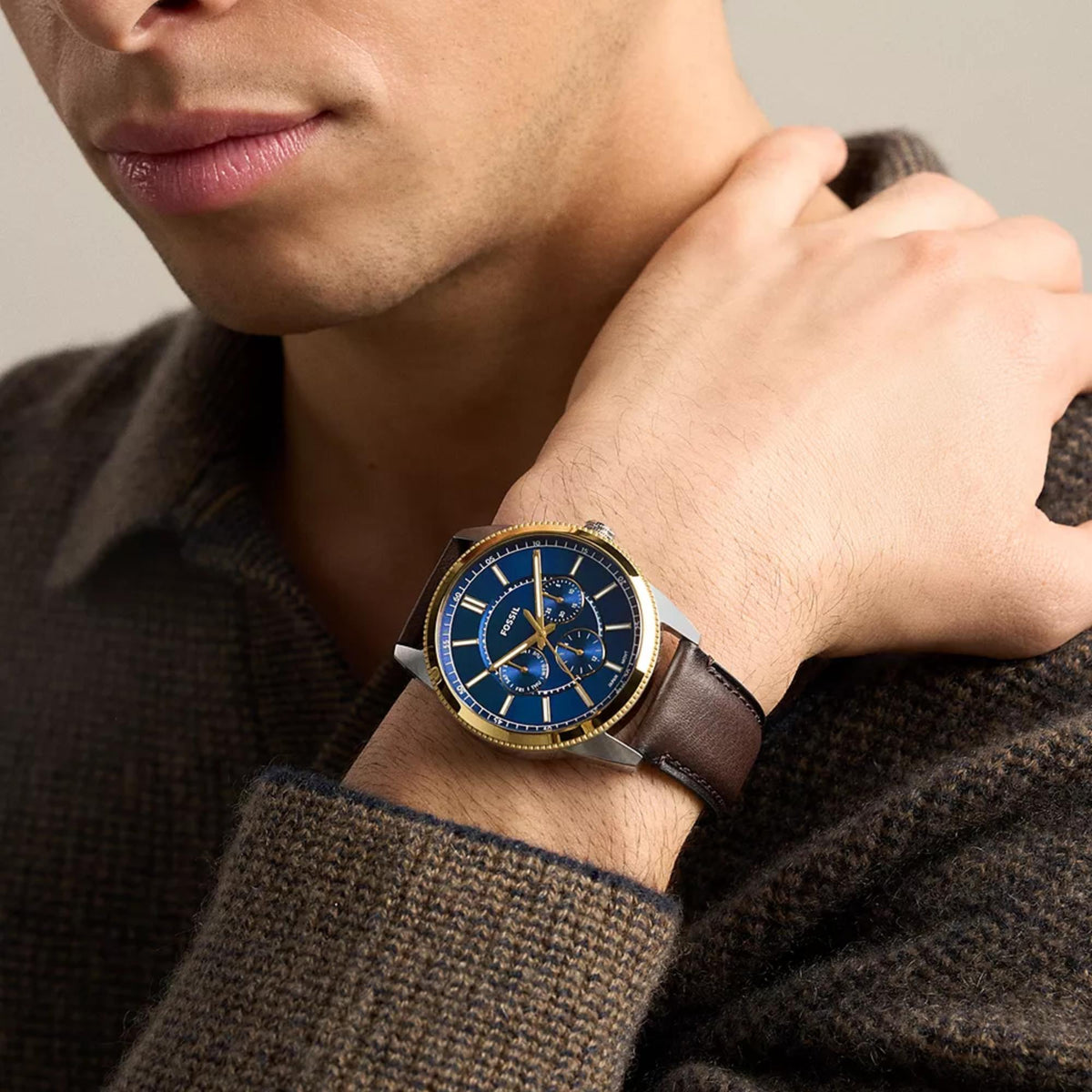 On-wrist view of the Fossil Pearson FS6195 quartz timepiece highlighting the blue multifunction dial and two-tone steel case
