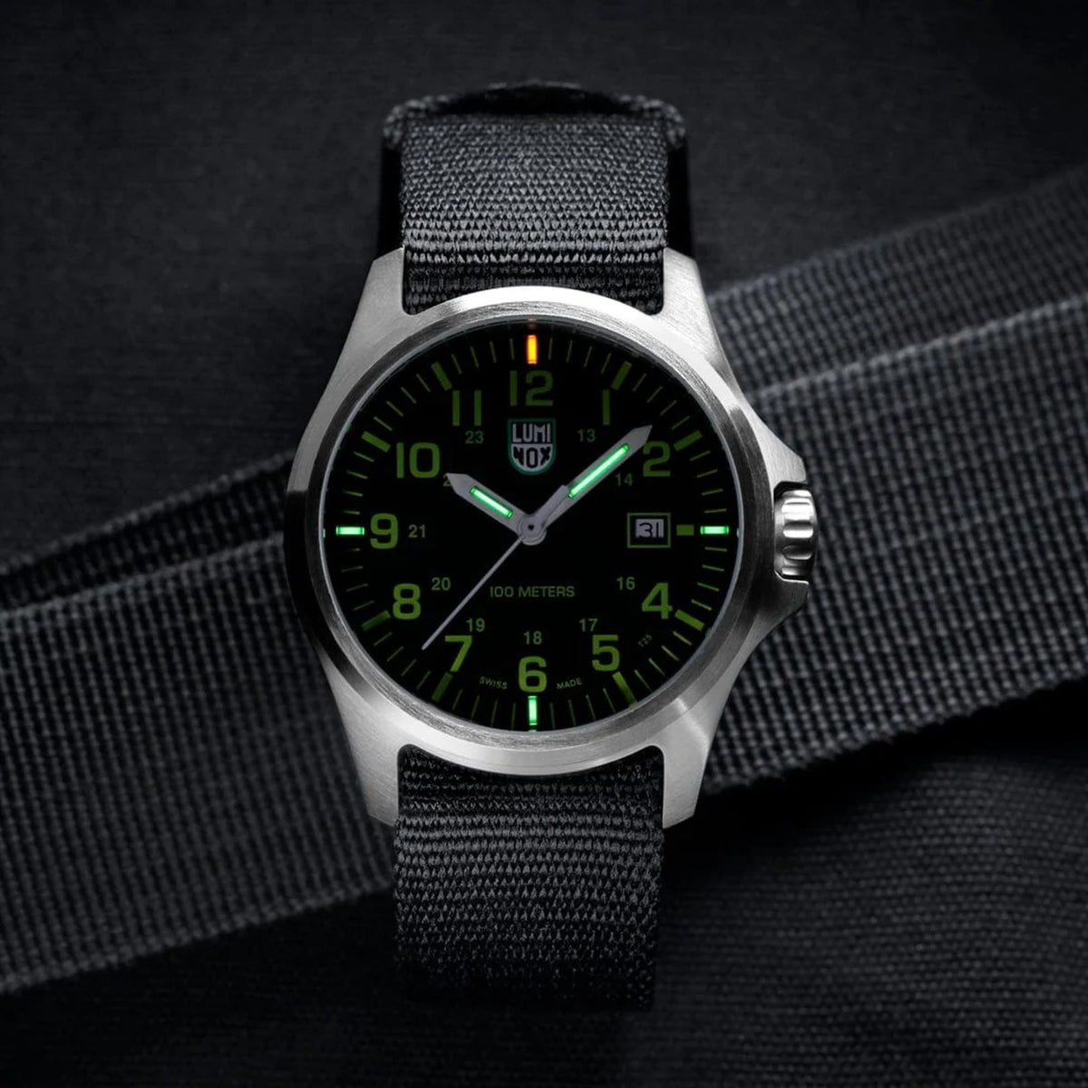 The Luminox G-Collection 'Moon Valley' 2500 Series X2.2517 watch angled on a dark background, showcasing the green night vision tubes on the black dial and silver case