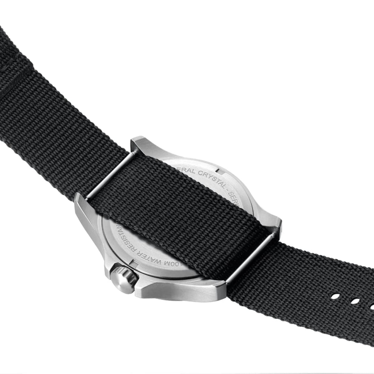 An angled shot of the back of the stainless steel case of the Luminox G-Collection 'Moon Valley' 2500 Series X2.2517 watch, with the black nylon strap threading through the lugs
