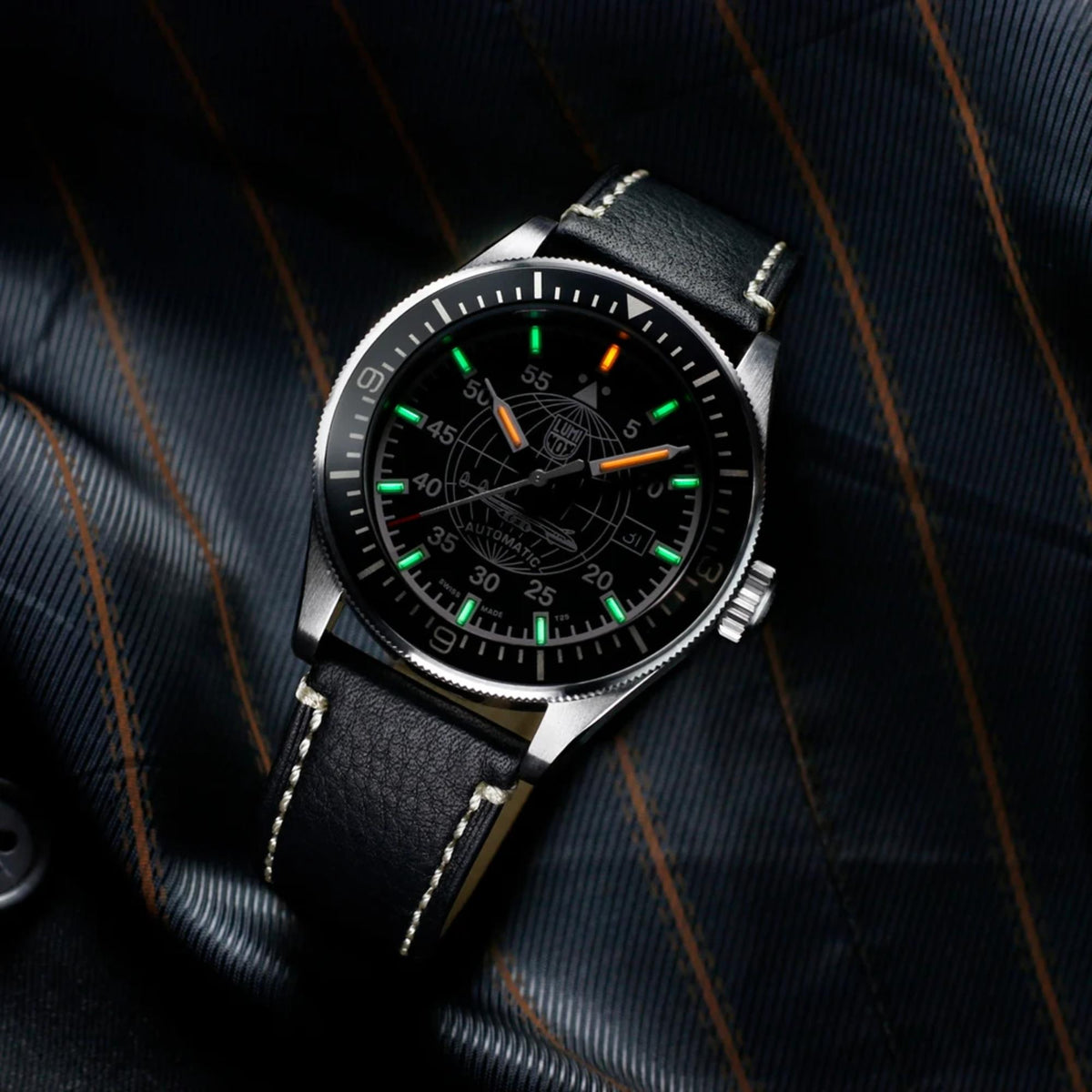 Luminox Constellation 9600 Series XA.9601 automatic watch angled view with black leather strap displayed on textured background