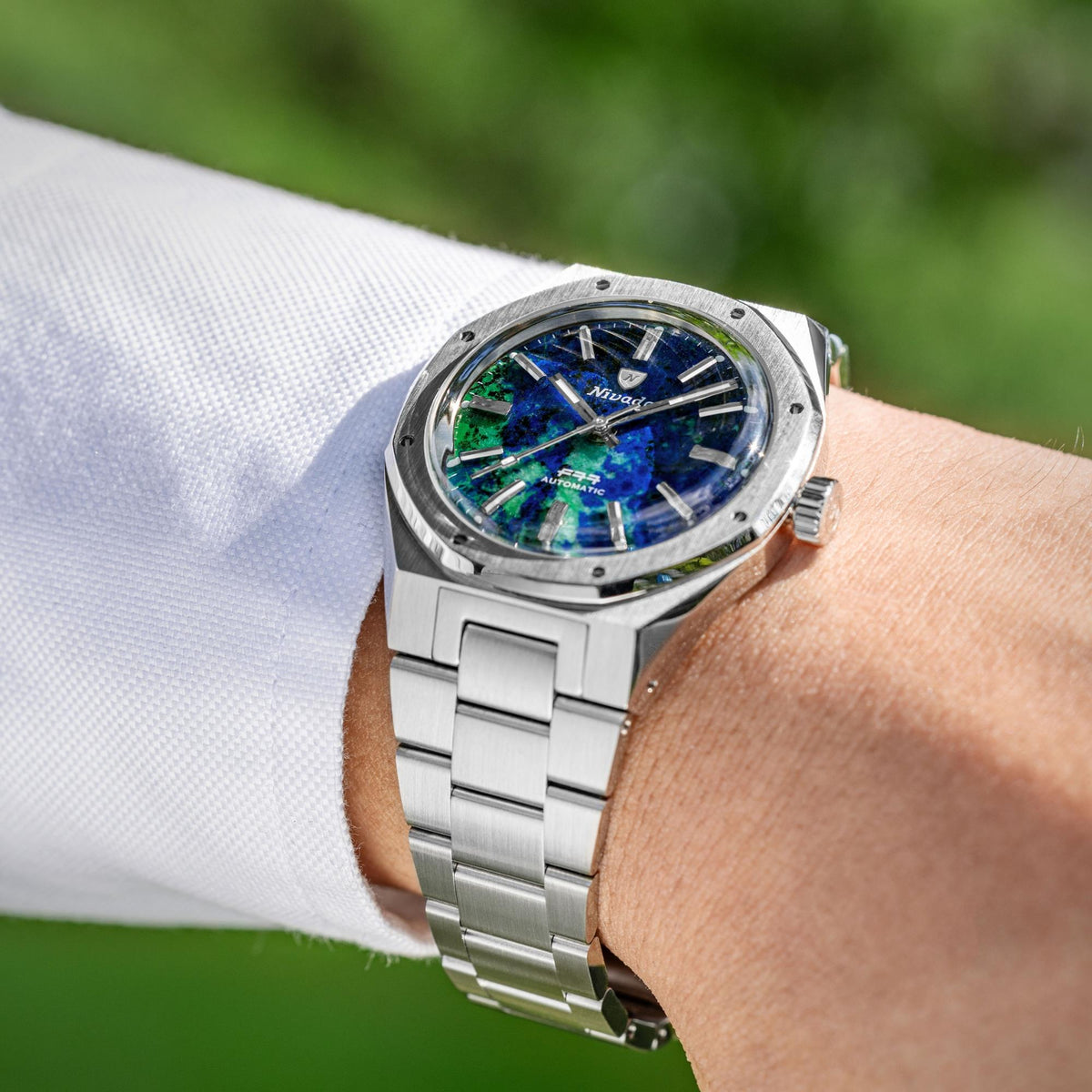 Nivada Grenchen F77 68056A77 on wrist shot displaying azurite dial with steel bezel profile