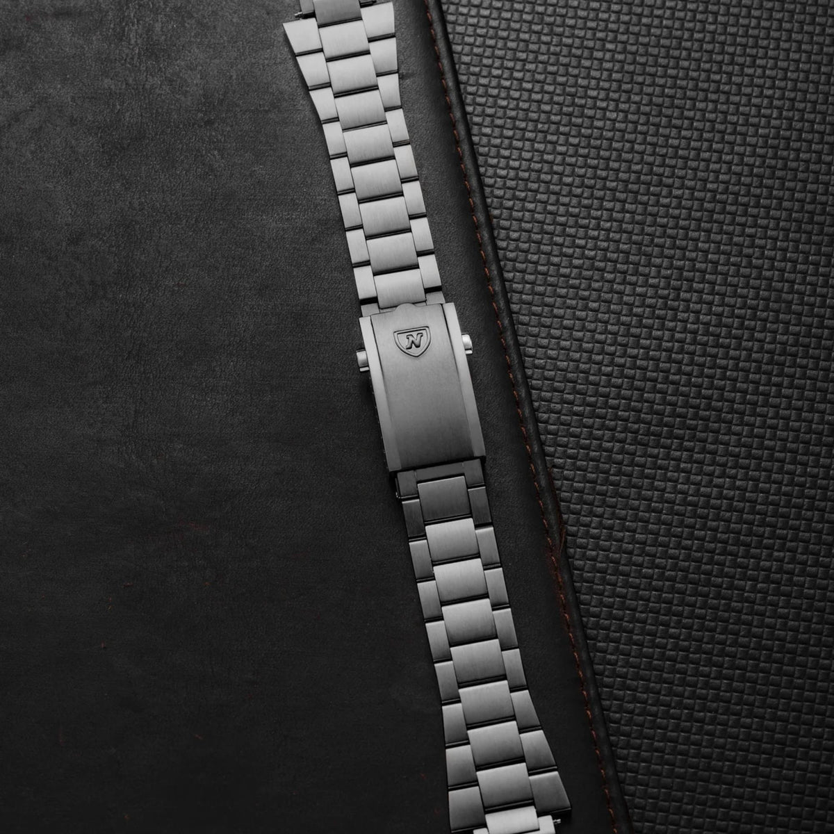 Nivada Grenchen Autochron NZ45PB1 flat lay view featuring silver steel bracelet link construction and folding buckle