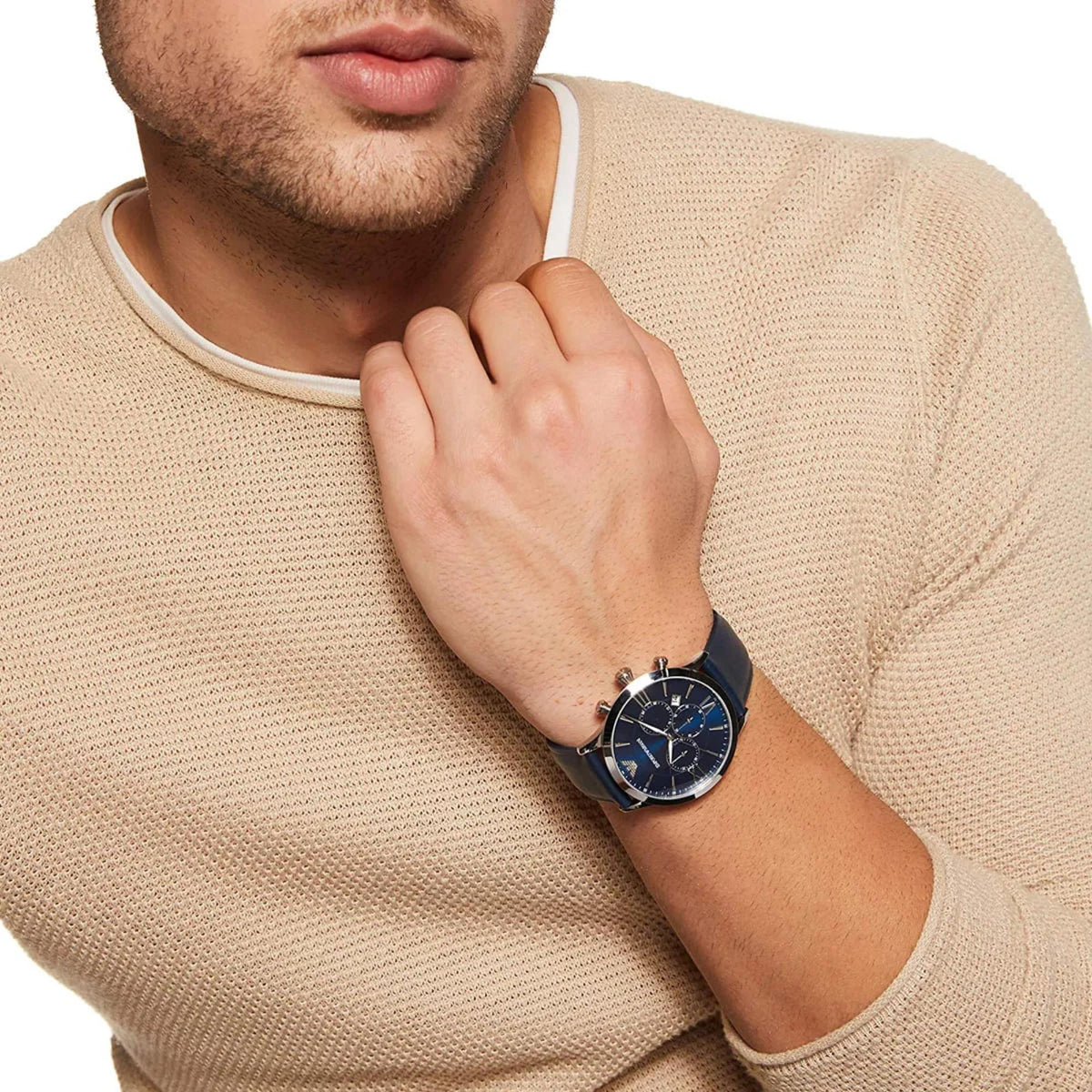 Emporio Armani Giovanni AR11226 wrist shot featuring blue chronograph dial with mens beige jumper
