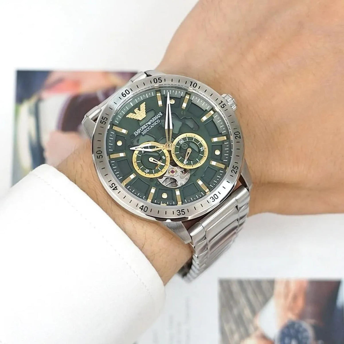 Emporio Armani Mario AR60053 wrist shot showcasing green dial with automatic open heart feature and steel case