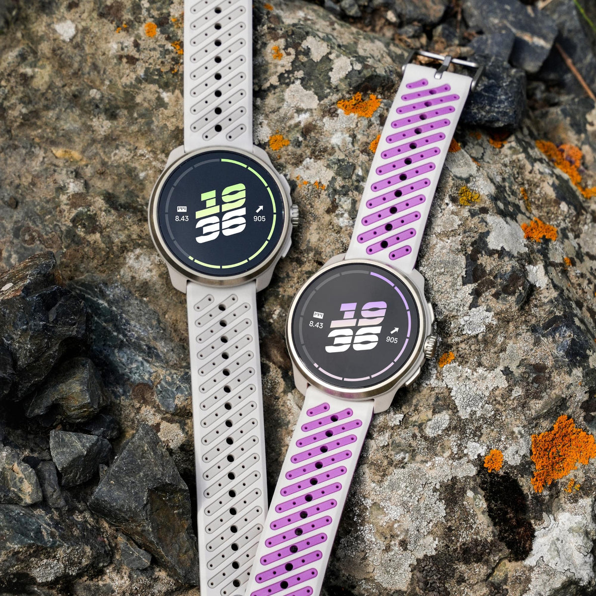 Suunto Race 3S SS051647000 top view displaying digital smart fitness watches resting on rocky terrain