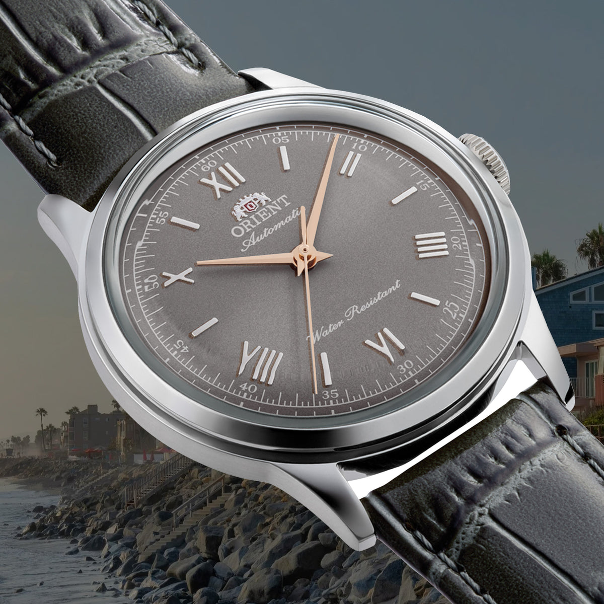 Orient Bambino classic automatic watch featuring a grey sunburst dial, Roman numerals, rose gold hands, and grey leather strap