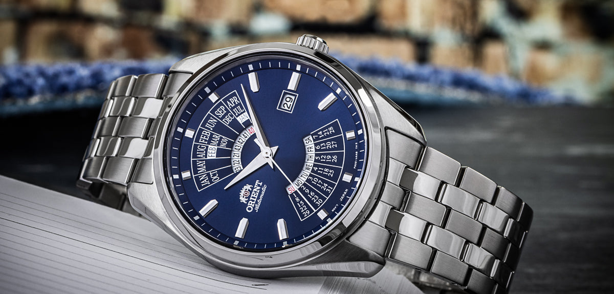 Men's automatic wristwatch with blue dial and silver steel bracelet, three-quarter view