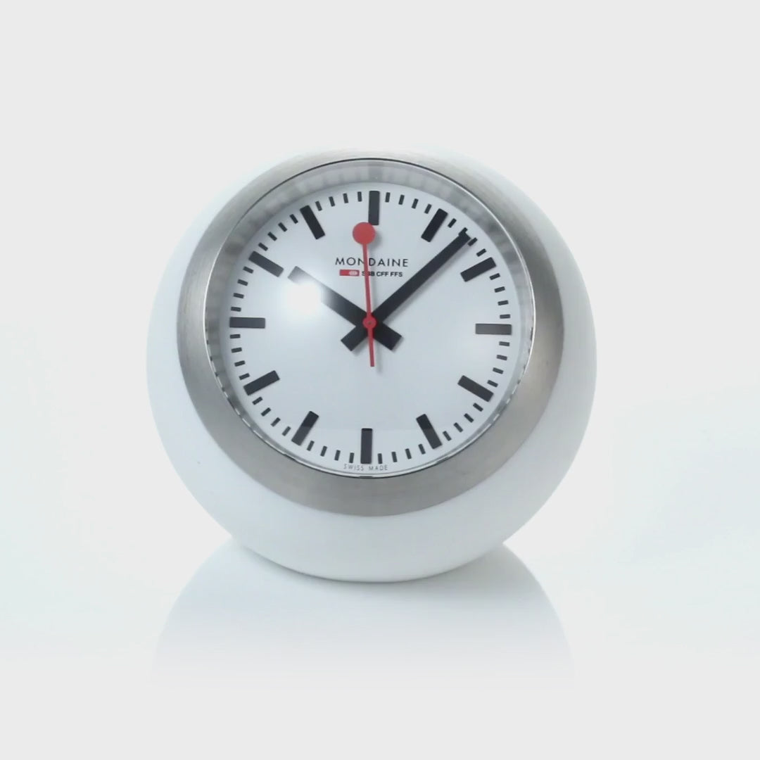 Mondaine Globe Table Clock A660.30335.16SBA, standing centered on a seamless light background