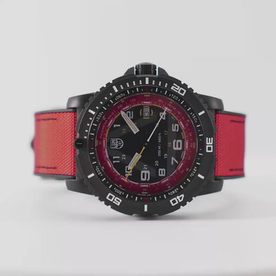 A close-up rotating video of the Luminox ICE-SAR XL.1095 watch, showcasing its black carbon case and red rubber-textile strap