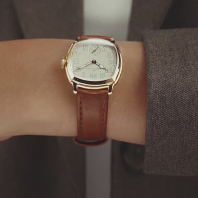 Hamilton American Classic Cushion Mechanical H36119520 close-up wrist view showing beige dial with yellow gold-tone steel case