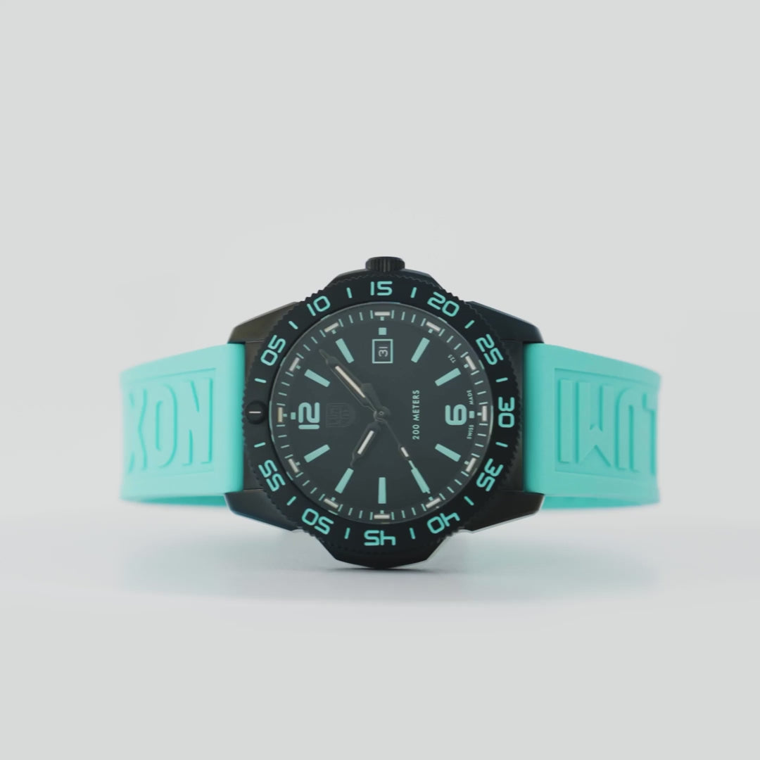 Front-facing studio shot of the Luminox Pacific Diver XS.3124.N.SET showcasing bright turquoise bezel markings and a matching rubber band