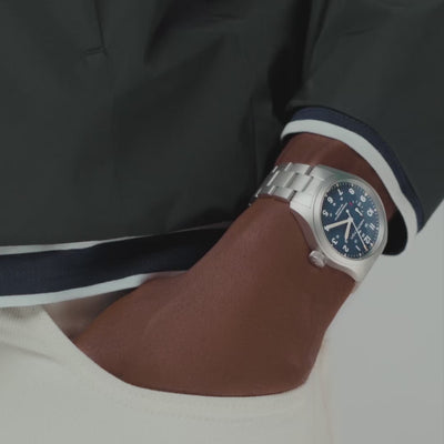 Hamilton Khaki Field watch with deep blue dial and stainless steel bracelet on wrist
