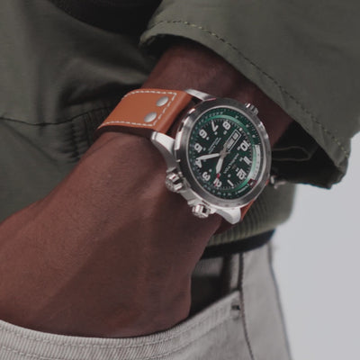 Hamilton Khaki Aviation H77735560 automatic watch close-up wrist shot featuring green dial and brown leather strap