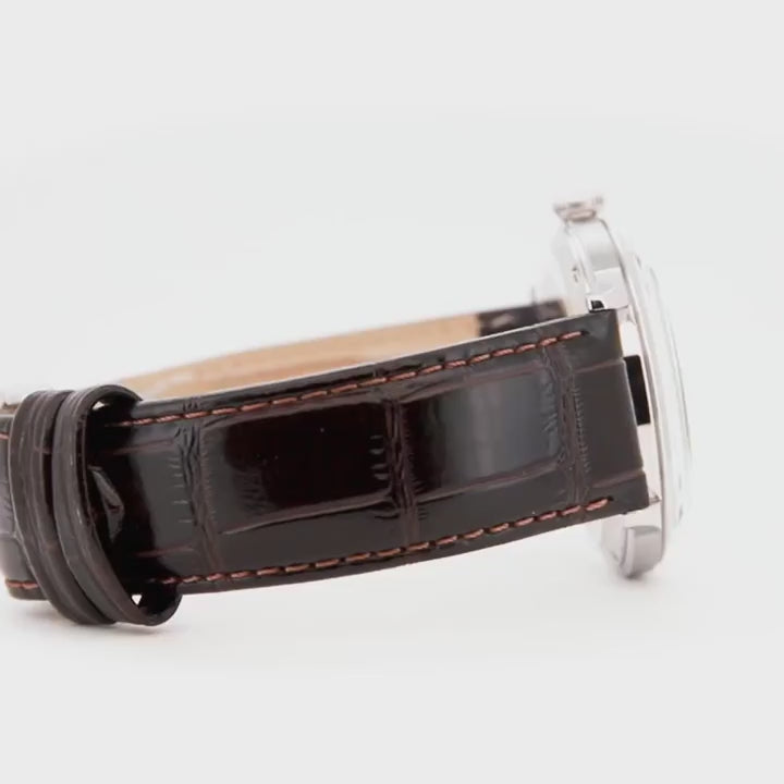Orient Bambino TAC00009W0 timepiece showing the dark brown leather strap and silver buckle closure