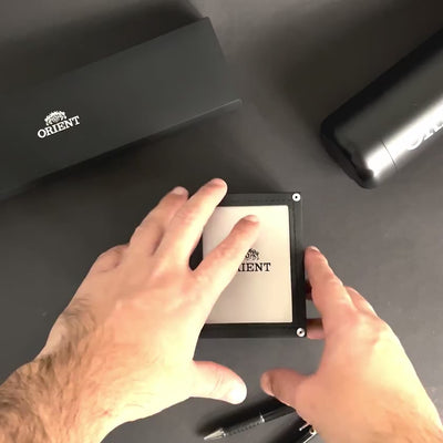 Hands opening official presentation box for Orient Contemporary RA-AA0C01B39B mechanical wrist watch