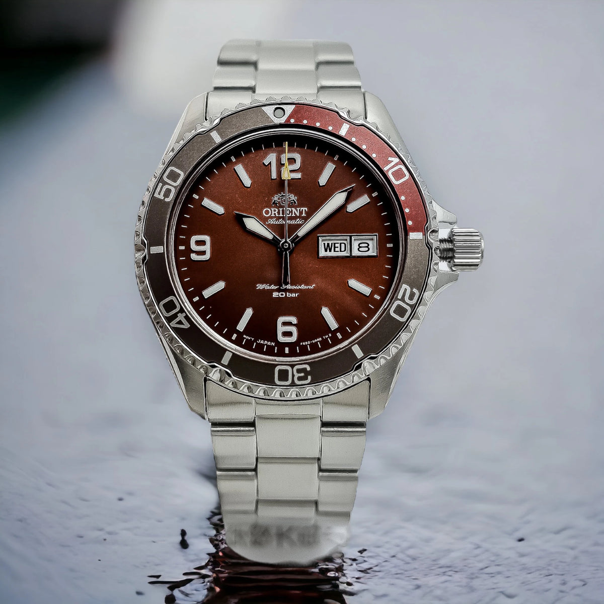 Men's stainless steel diver watch with red bezel and brown dial, date window