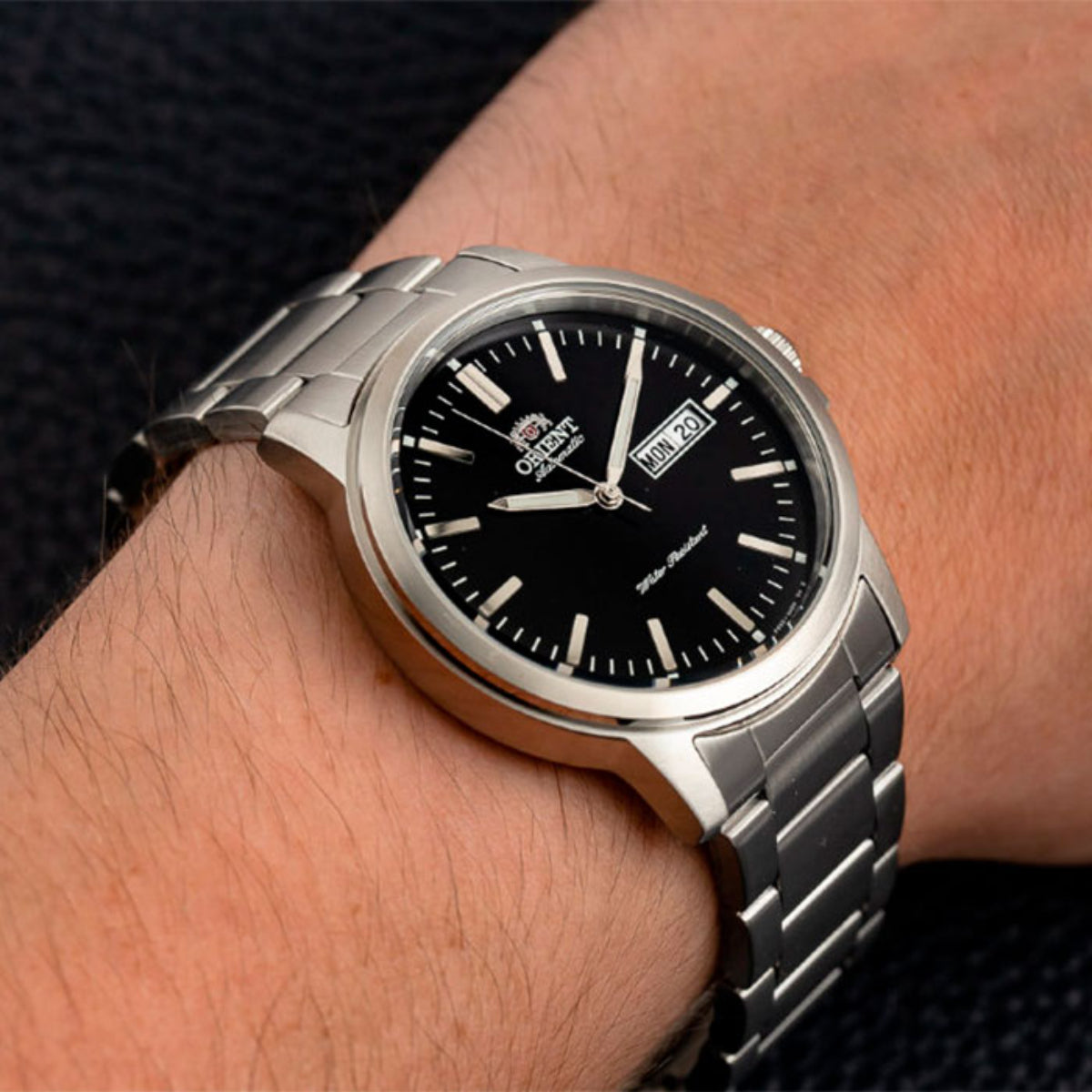 Orient Contemporary RA-AA0C01B39B self-winding mens timepiece with black dial and stainless steel bracelet on wrist
