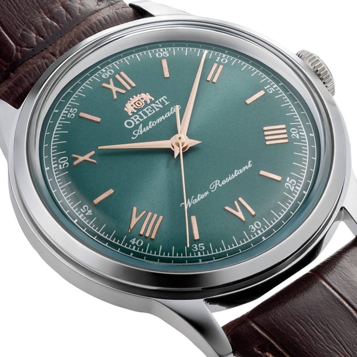 Orient Bambino RA-BB0001E30B angled front perspective featuring green dial and copper hands with brown leather band