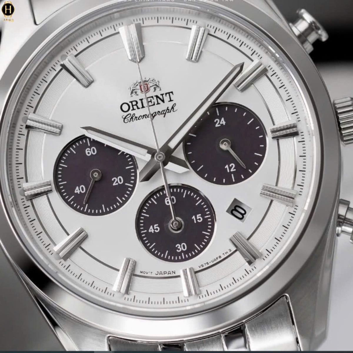 Close-up of white dial men’s chronograph watch with dark subdials and baton markers