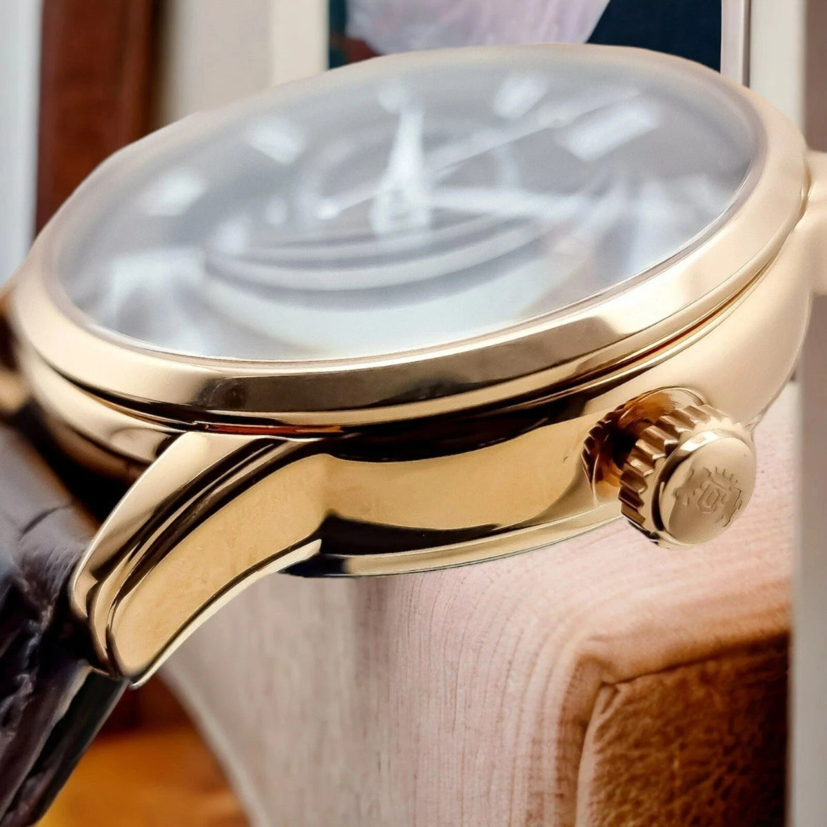 Orient Bambino Sun and Moon rose gold-tone watch RA-AK0009T30B case with crown detail and dark leather strap edge
