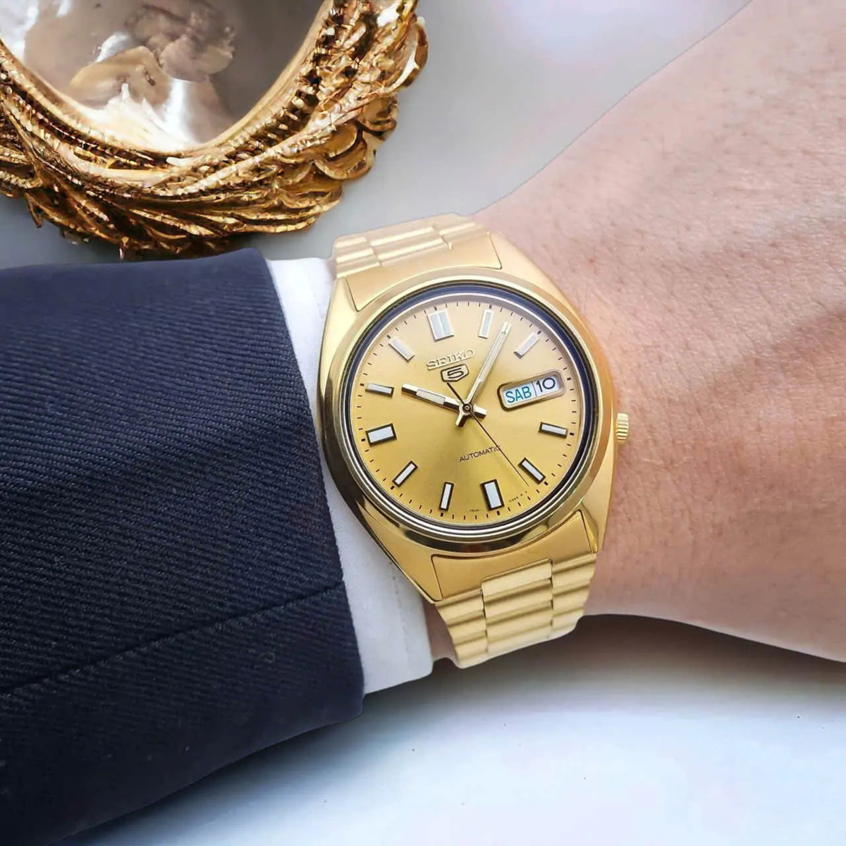 Seiko 5 SNXS80K1 automatic gold tone dial and steel bracelet watch on wrist