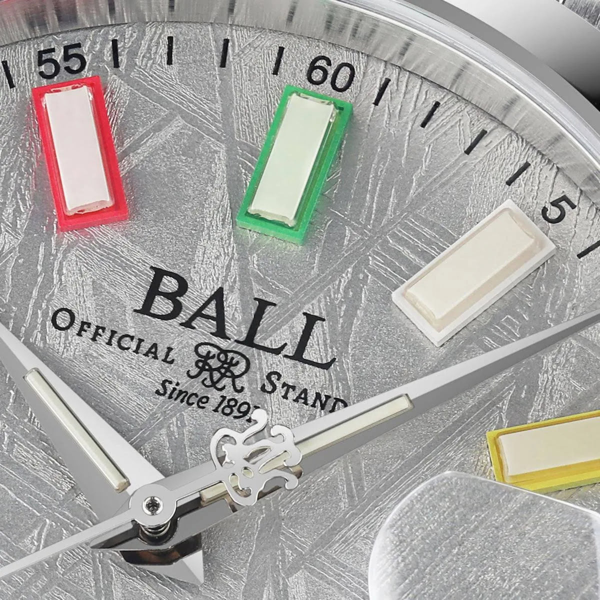 Close-up of textured silver dial with colorful markers and "BALL" branding