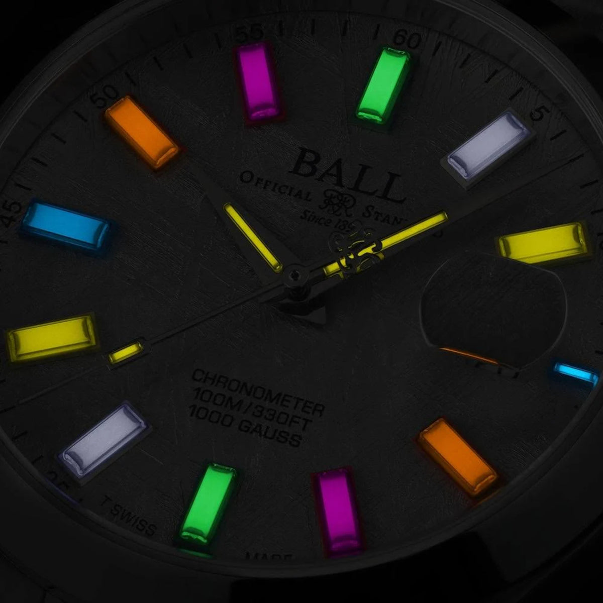 BALL Engineer III Marvelight NM9026C-S46C-MSLR close-up view displaying glowing rainbow gas tubes on dark dial