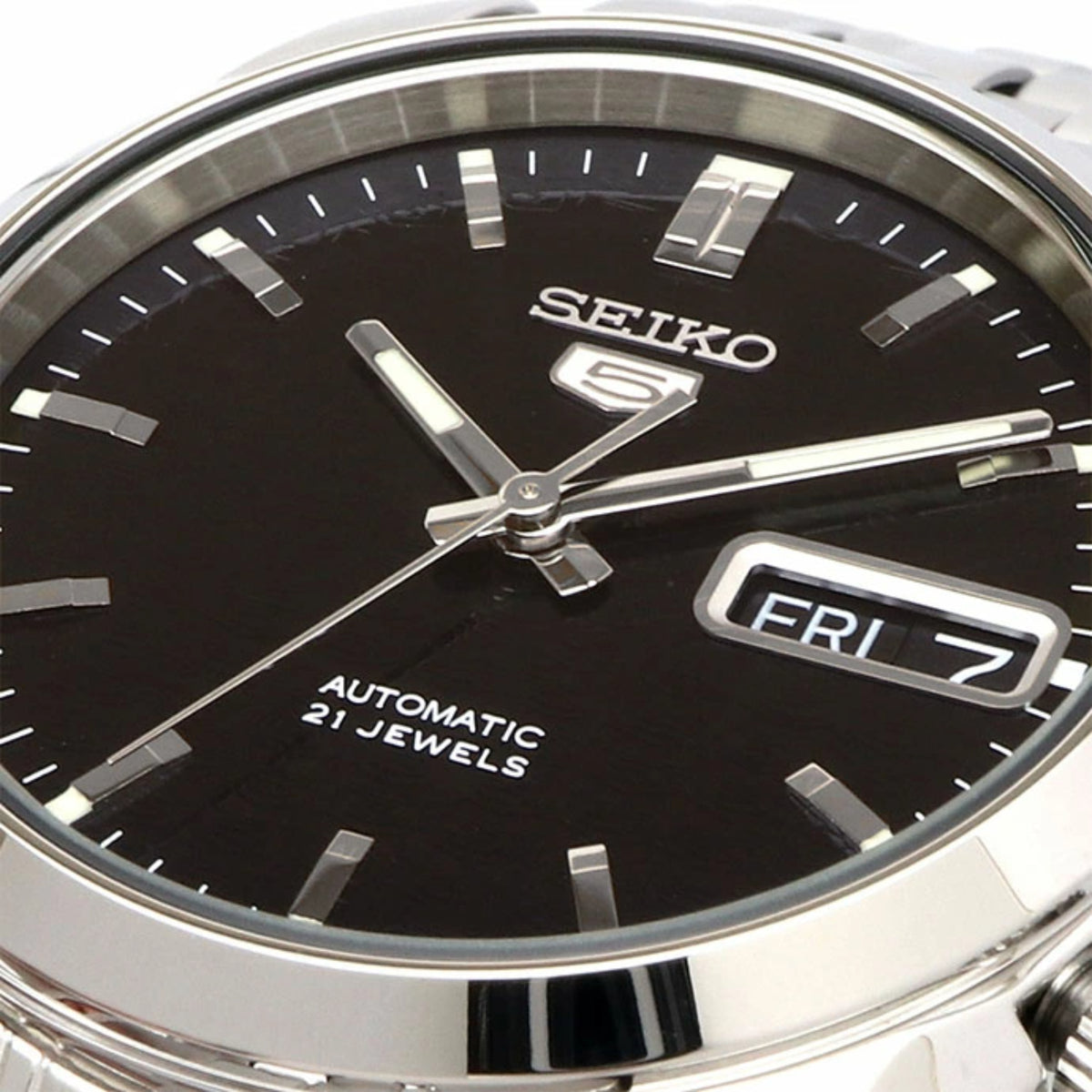 Close-up of SEIKO 5 SNK357K1 automatic watch dial with dark face and FRI date window