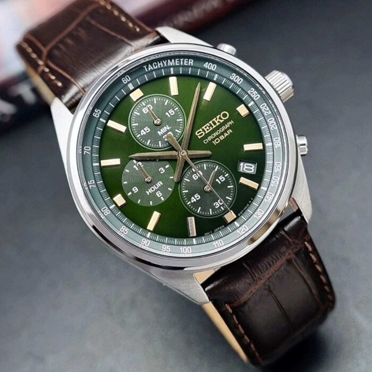 Close-up of Seiko engraved buckle on brown leather strap of SSB385P1