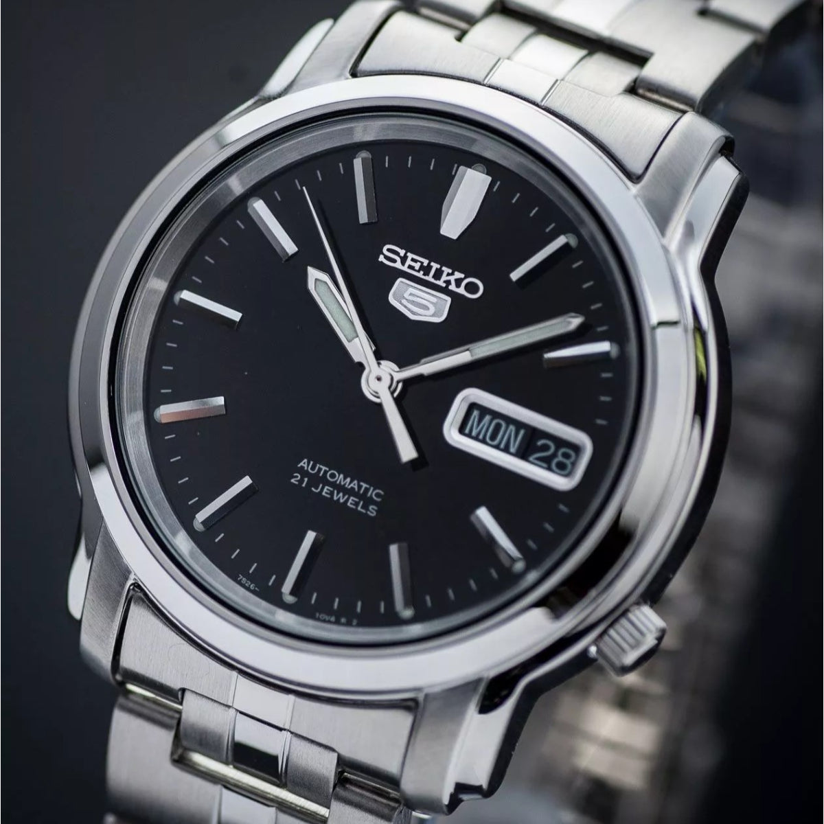Seiko 5 Classic SNKK71K1 close-up view showing black dial detail and steel bezel